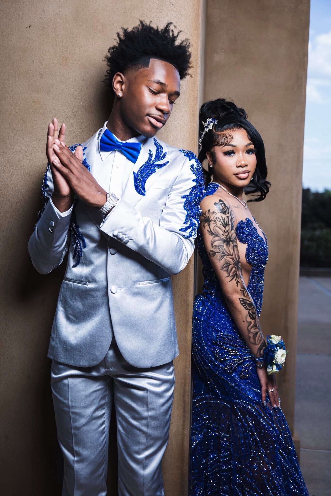 Couple in matching silver and cobalt blue evening wear