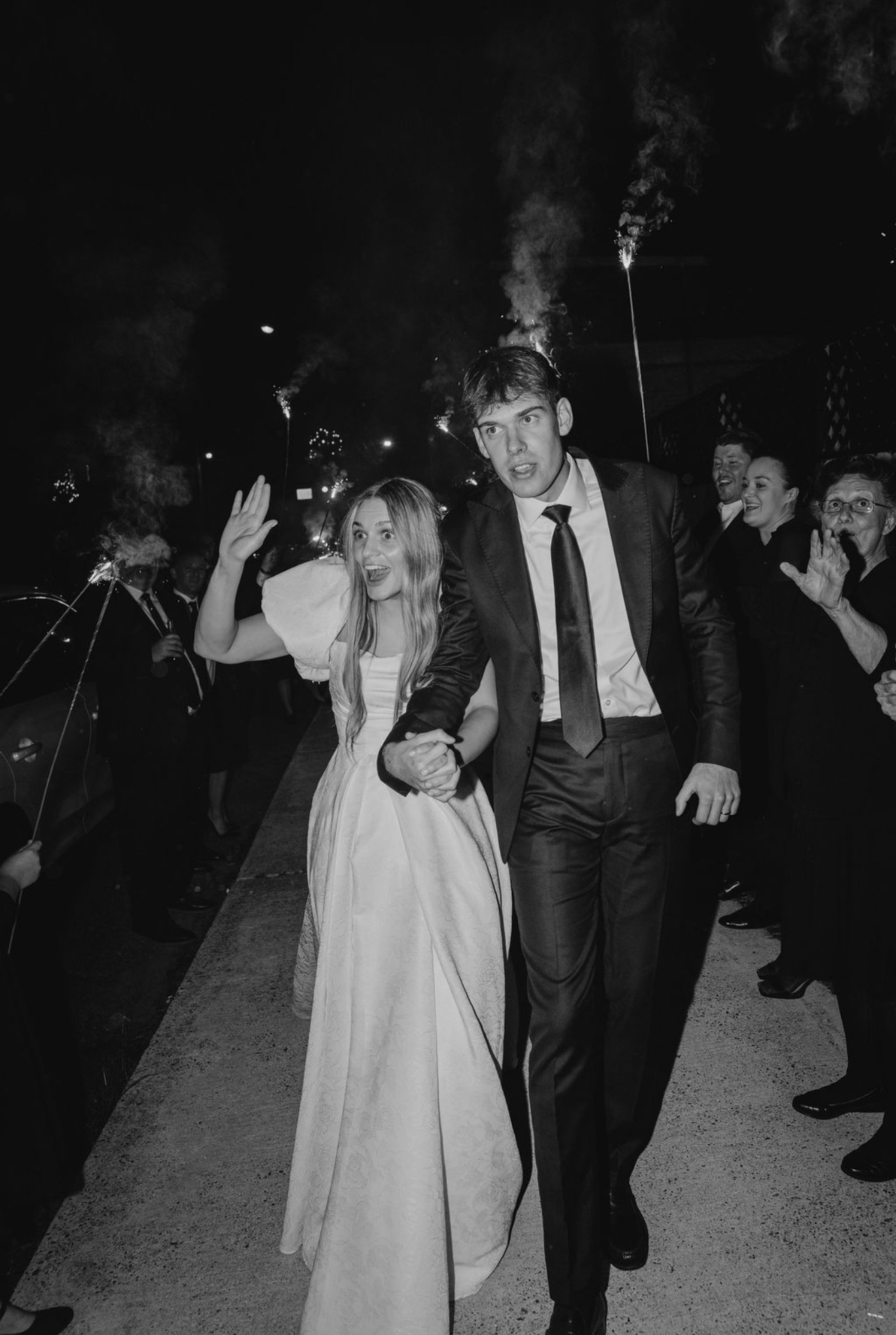 Couple's sparkler exit, groom in dark suit